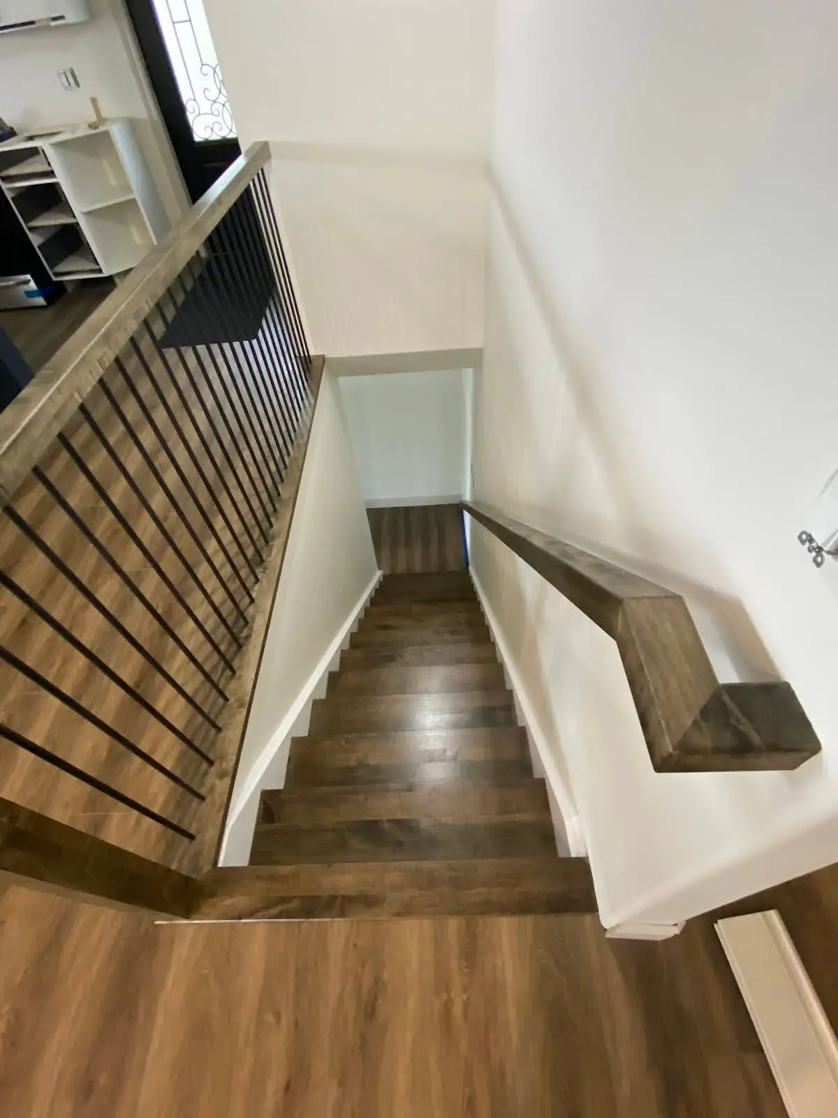 wooden staircase decending to basement - custom wooden railing and banaster